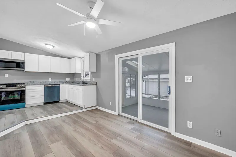 Kitchen looking toward a sliding door onto the enclosed porch