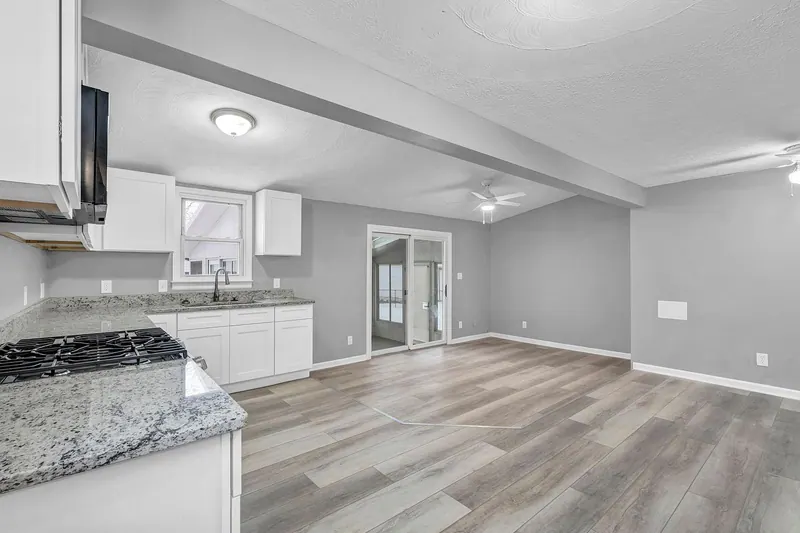 Kitchen from the cooktop end, with a window above the sink