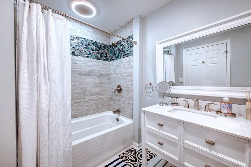 Bathroom with a deep tub and shower, beside the vanity