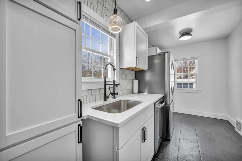 Kitchen island with a deep sink and pendant lights above it