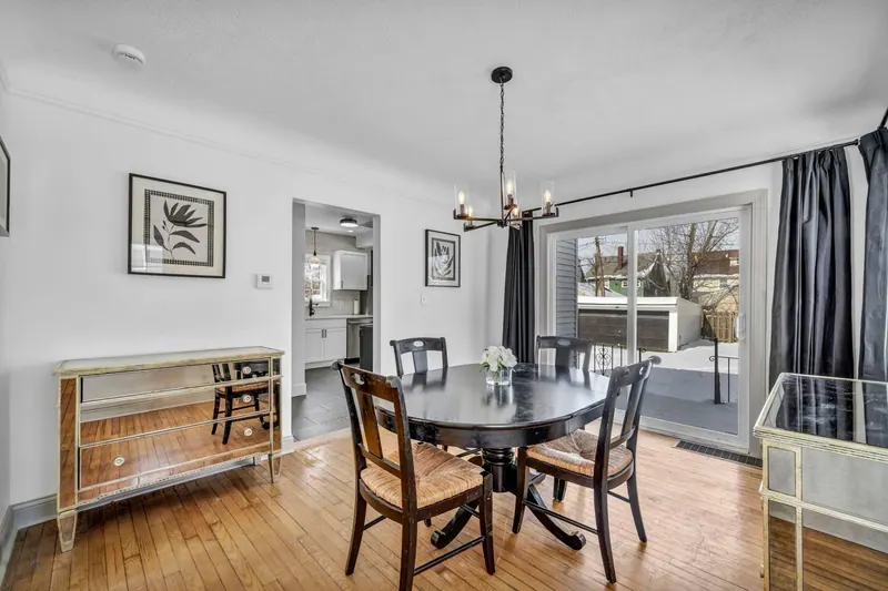Dining room from the other side, with a sideboard and a window to the yard