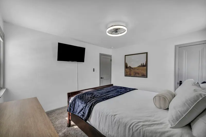 Third bedroom with a queen bed and a wall mounted television