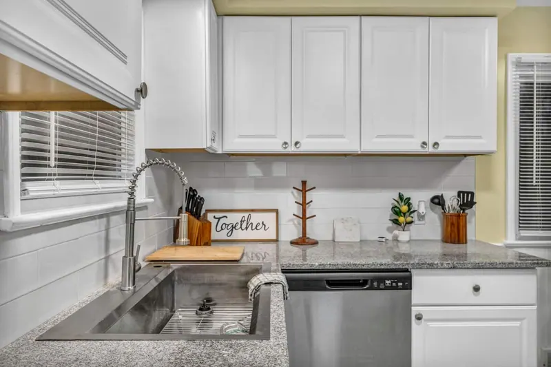 Kitchen counter with a granite top, deep sink and stainless dishwasher