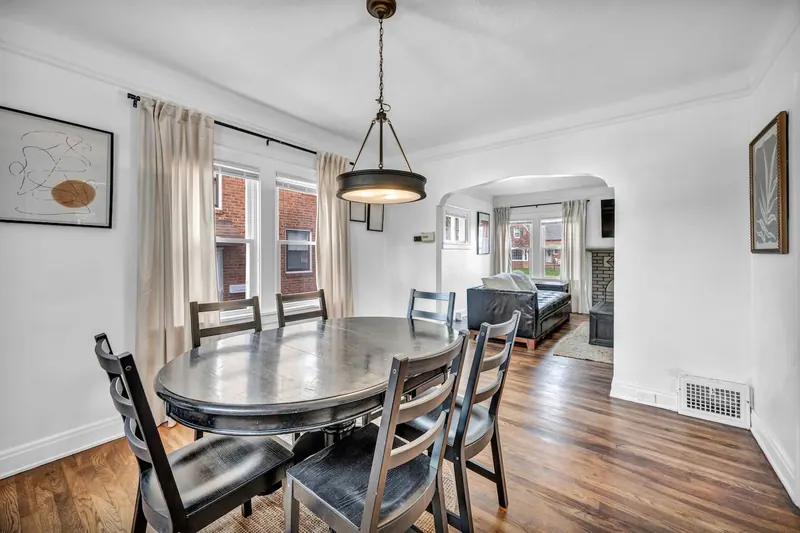 Dining room with an oval table and six chairs under a pendant light