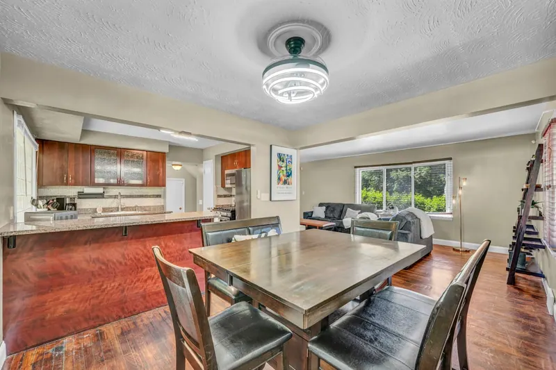Dining room with a wooden table and six chairs on hardwood