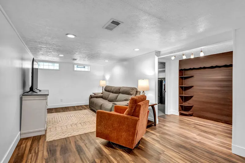 Finished basement from the other end, with a rug across the floor