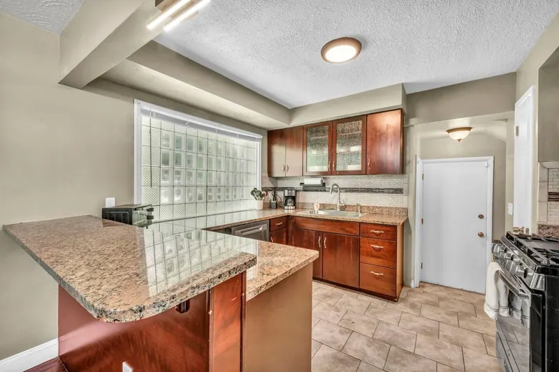 Kitchen counter running under a glass block window
